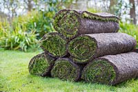 Pile of fresh turf rolls for resurfacing lawn