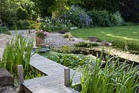 Pond with wooden decking path across