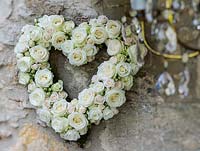 Wedding bouquet in heart shape, on the outside of barn