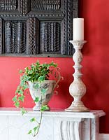 Trailing ivy in container on mantelpiece