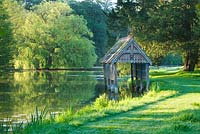 The recently restored, listed boat house on the banks of the river nar. Narborough Hall Gardens, Norfolk