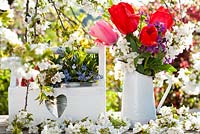 Floral display of spring flowers includes tulips, honesty, cherry and forget me nots.