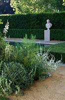 BrandAlley Renaissance garden Bronze medal. Chelsea Flower Show 2014. Italianate garden with long canal pool and classical bust sculpture. Border of foliage planting with fennel. 