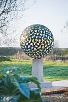 The Mantle - a verigris bronze sphere consisting of dozens of individual bronze petals welded together 