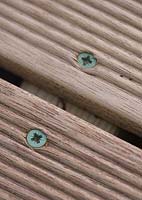 Close up of decking showing wood screws 