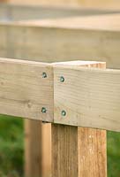 Constructing a circular deck - corrosion resistant deck bolts hold wooden joists together for decking