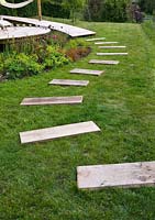 Pieces of oak laid into lawn as stepping stones
