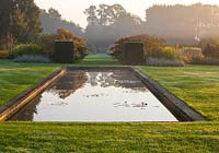 Mist rises off the canal at dawn. Waterperry Gardens, Oxfordshire