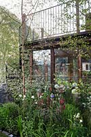 Vital Earth The Night Sky Garden. View to the wooden house with spiral straircase surrounded by Verbascum 'Petra', Aquilegiakristall, Aquilegia vulgarisvar. alba, Buxus, Allium,   
