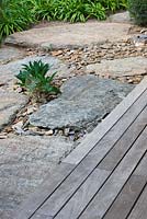 Wooden decking, slate gravel and rocks 