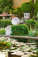 Waterlily pond with duck ornament and table 