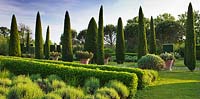 Clipped cypresses - cupressus sempervirens, viburnum tinus, lavenders, rosemary and box. Les Confines, Provence, France