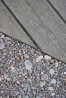  Pebbles bordering wooden decking -  From the Moors to the Sea Garden. 