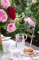 Jug of David Austen Roses on a table setting
