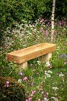 Wooden bench amongst Anthriscus sylvestris - Cow Parsley, Silene dioica - Red Champion and Hyacinthoides non-scripta - Bluebell, 'Bringing Nature Home', show garden, RHS Malvern Spring Festival 2014