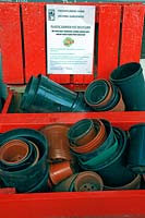 Plastic garden pot recycling at Freightliners Farm, pots recycled in red wooden box, Holloway, London Borough of Islington.