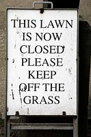 Sign or notice saying - This Lawn is now closed please keep off the grass - London UK