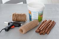 Cinnamon sticks to decorate recycled yoghurt pot  