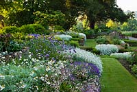 Formal raised beds of Cerastium tomentosum - snow-in-summer, Viola, Veronica, Hosta, Saxifraga, Dianthus, Erysimum and Alliums - Sunken Garden West Dean Sussex 