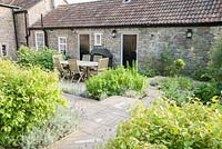 Dining area with small herb garden beside it. Old Rectory, Batcombe, Somerset, UK