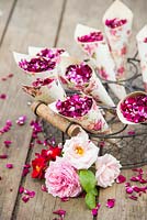 Confetti of Arborio rice and dried rose petals in handmade cones made from vintage books and decorative paper. 