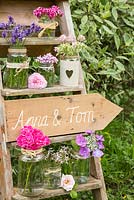 Wedding sign on ladder accompanied with Hydrangea flowers, Lavandula, Scented pelargoniums, Rosa and Dianthus barbatus. 