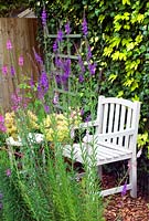 Painted wooden seat and table in garden setting