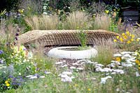 Silver. Best Show Garden. Jordans Wildlife Garden. Design: Selina Botham. Benches of straw bales near pool.