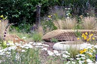 Benches of staw bales near pool - Jordans Wildlife Garden. Design: Selina Botham - Silver. Best Show Garden. RHS Hampton court flower show 2014
