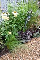 Space to Connect and Grow - view of garden made from industrial reclaimed and reused materials planting, Echinacea pupurea 'White Spider', Eryngium, Heuchera 