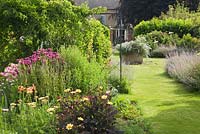 The Sundial Garden. Mixed herbaceous perennials, annuals and dahlias. Hall Farm Garden at Harpswell near Gainsborough in Lincolnshire. July 2014.