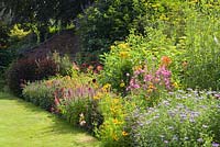 One of the double herbaceous borders. Hall Farm Garden at Harpswell near Gainsborough in Lincolnshire. July 2014.