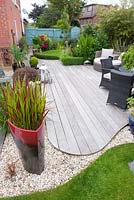 Curved sinuous edge of Ipe hard wood deck contrasts with curve of lawn with crisp metal edging and 20 ml gravel