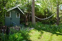 Children's Wendy House with hammock in country garden in Summer