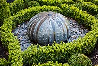 Decroative Sea Urchin Water Feature in a Box parterre with slate stones and gravel