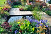 Extensive planting in flower beds with central pool. Description: The Narrows Garden, Designer: Phillippa Probert, Sponsor: Beers Building Supplies 