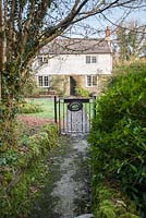 Garden gate with slate sign painted with snowdrops. 