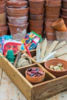 Potting bench in spring time - still life with saved seeds and gardening items