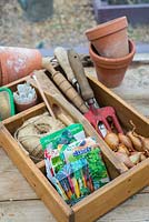 Springtime potting bench with onion sets ready for planting.