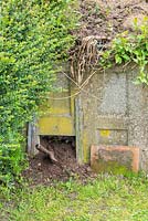 Reduntant concrete coal bunker used as compost bin