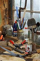 Garden tools, secateurs and shears on workshop bench, ready to be cleaned and sharpened