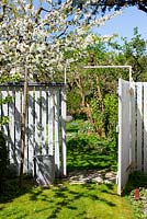 White wooden fence and gate leading into the garden