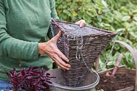 Placing basket in a bucket to add support whilst planting up. 