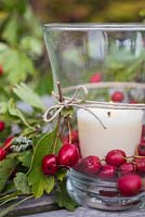 Candle in glass jar decorated with Crataegus - Hawthorn