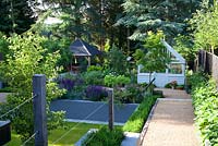 Contemporary garden split level garden with  greenhouse and summerhouse