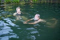 Couple swimming in their natural swimming pond - Sue and Ian Mabberley