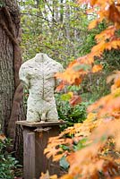 Torso of Leaves by Stephen Duncan made from marble, concrete and polymer. The Hannah Peschar Sculpture Garden designed by Anthony Paul, Landscape Designer