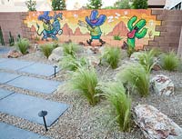 Garden surrounded by wall murals. Plants include Stipa tenuissima, Echinopsis pachinoi 