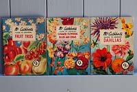 Close up of books - Mr. Cuthbert's guide to growing fruit trees, summer-flowering bulbs and dahlias. Antique illustrated booklets.