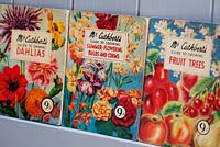 Close up of books - Mr. Cuthbert's guide to growing fruit trees, summer-flowering bulbs and Dahlias. Antique illustrated booklets.